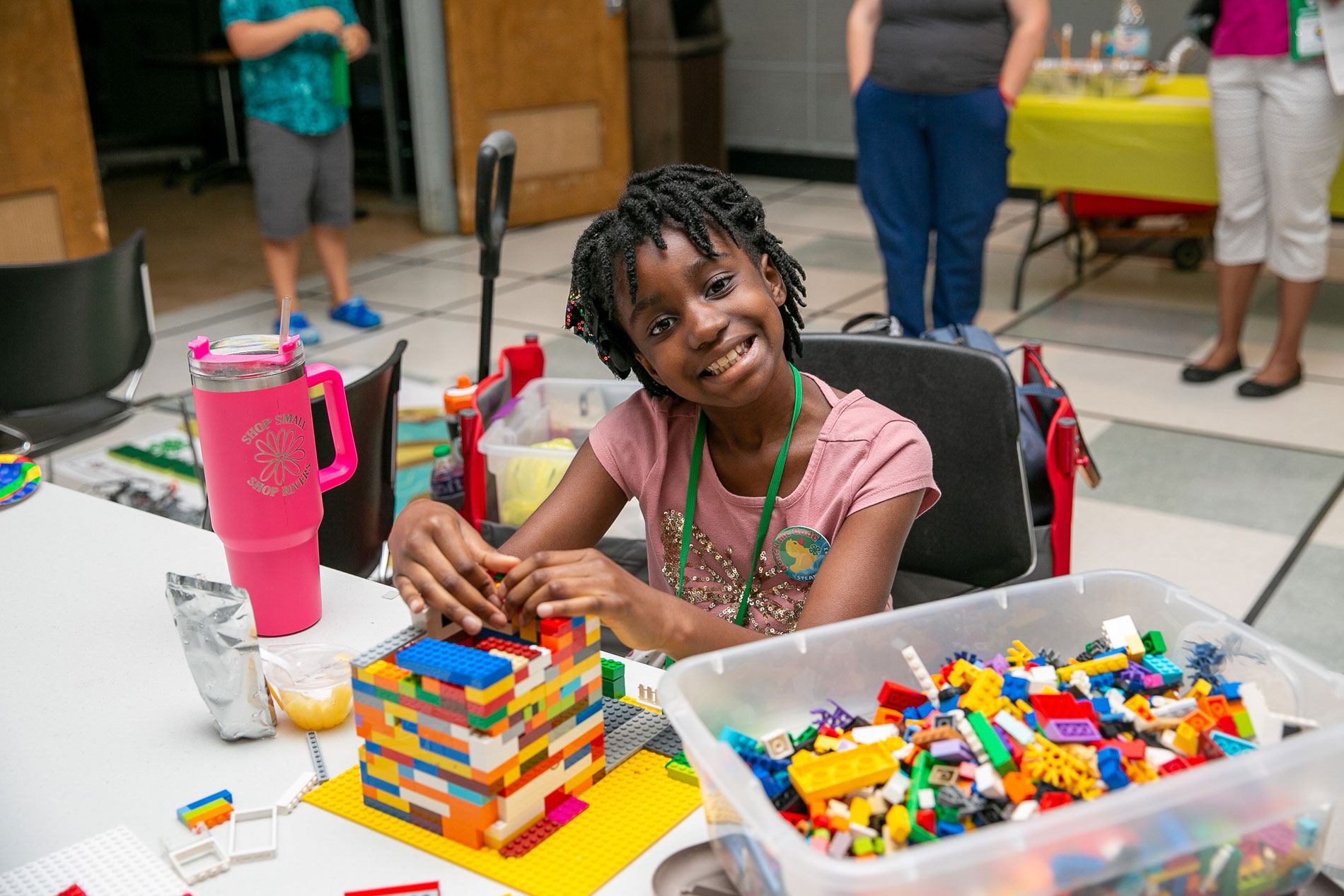 A girl building with LEGOs.