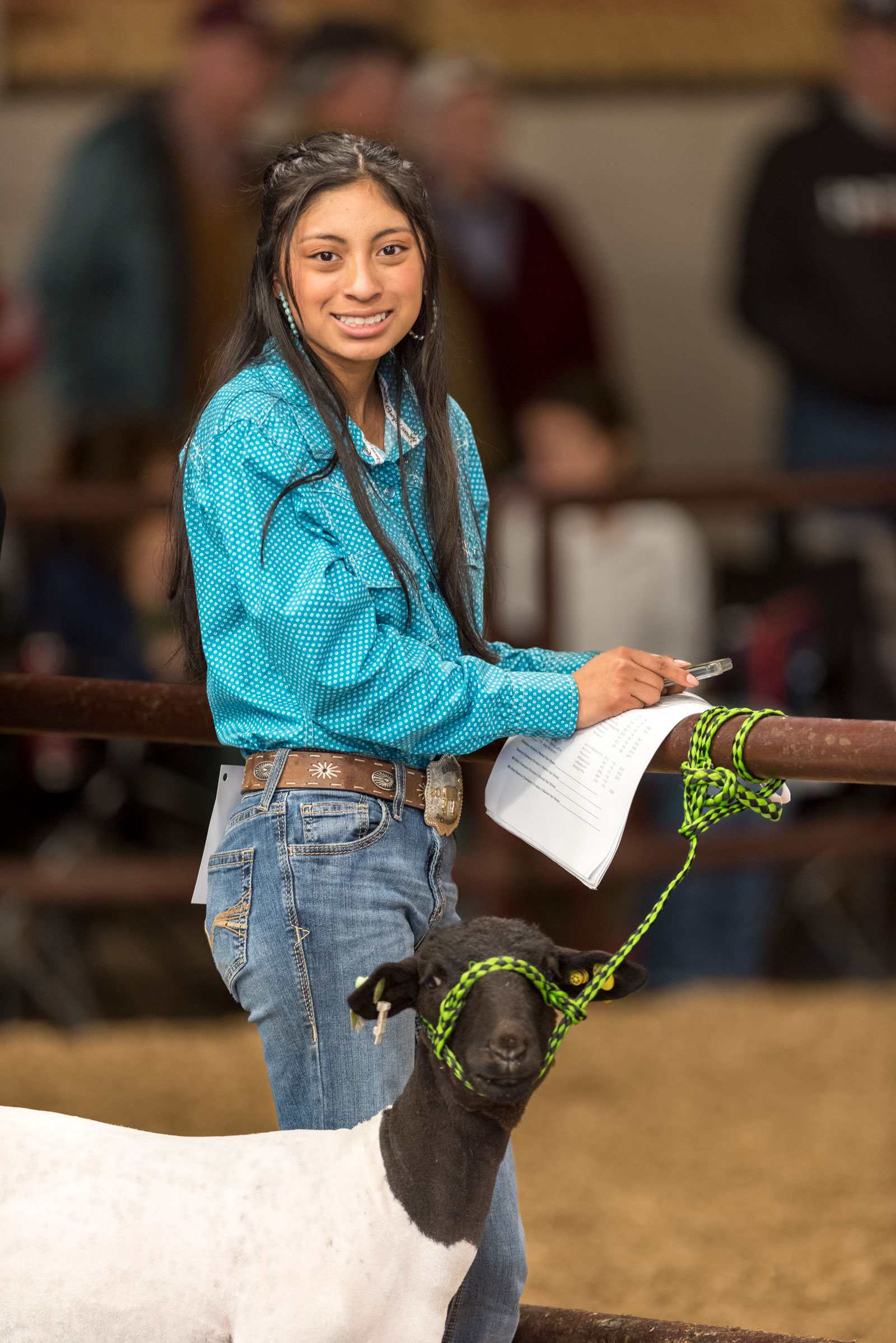 A girl showing a goat.