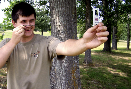 A student is demonstrating how to hold the BA angle gauge.