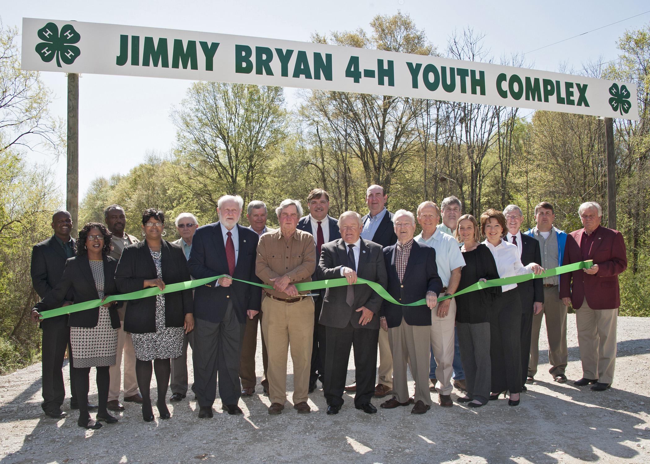 Mississippi State University Extension Service 4-H representatives, state and local officials, and industry representatives enjoy a beautiful day for a ribbon-cutting ceremony for the Jimmy Bryan 4-H Youth Complex in West Point April 10, 2014. Participants include Paula Threadgill, (front row, left), Angela Turner-James, Hobson Waits, Jimmy Bryan, Floyd McKee, Barney Jacks, Robbie Robinson, Paige Lamkin and Amy Berry; Lynn Horton (back row, left), Shelton Deanes, Preston Sullivan, Russell Jolly, Gary Jackso