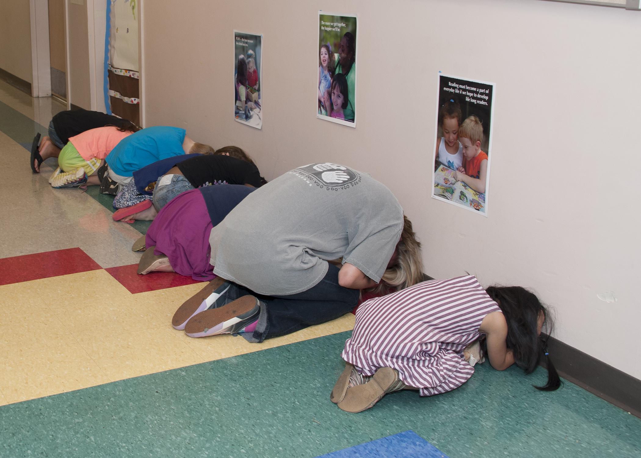 Preschoolers and workers practice together during a tornado drill at the Mississippi State University Child Development and Family Studies Center on July 16, 2014. (Photo by MSU Ag Communications/Kat Lawrence)