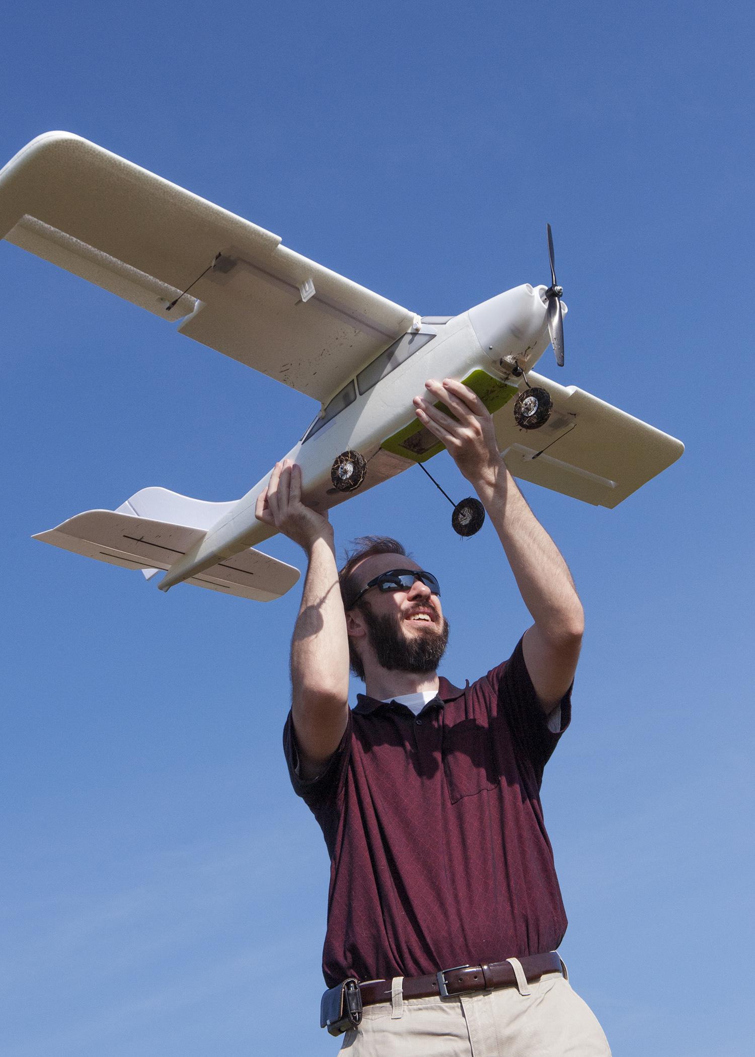 Lee Hathcock, a researcher and doctoral student at Mississippi State University, launches a Robota Triton unmanned aerial vehicle. (Photo by MSU Media Affairs/Beth Wynn)