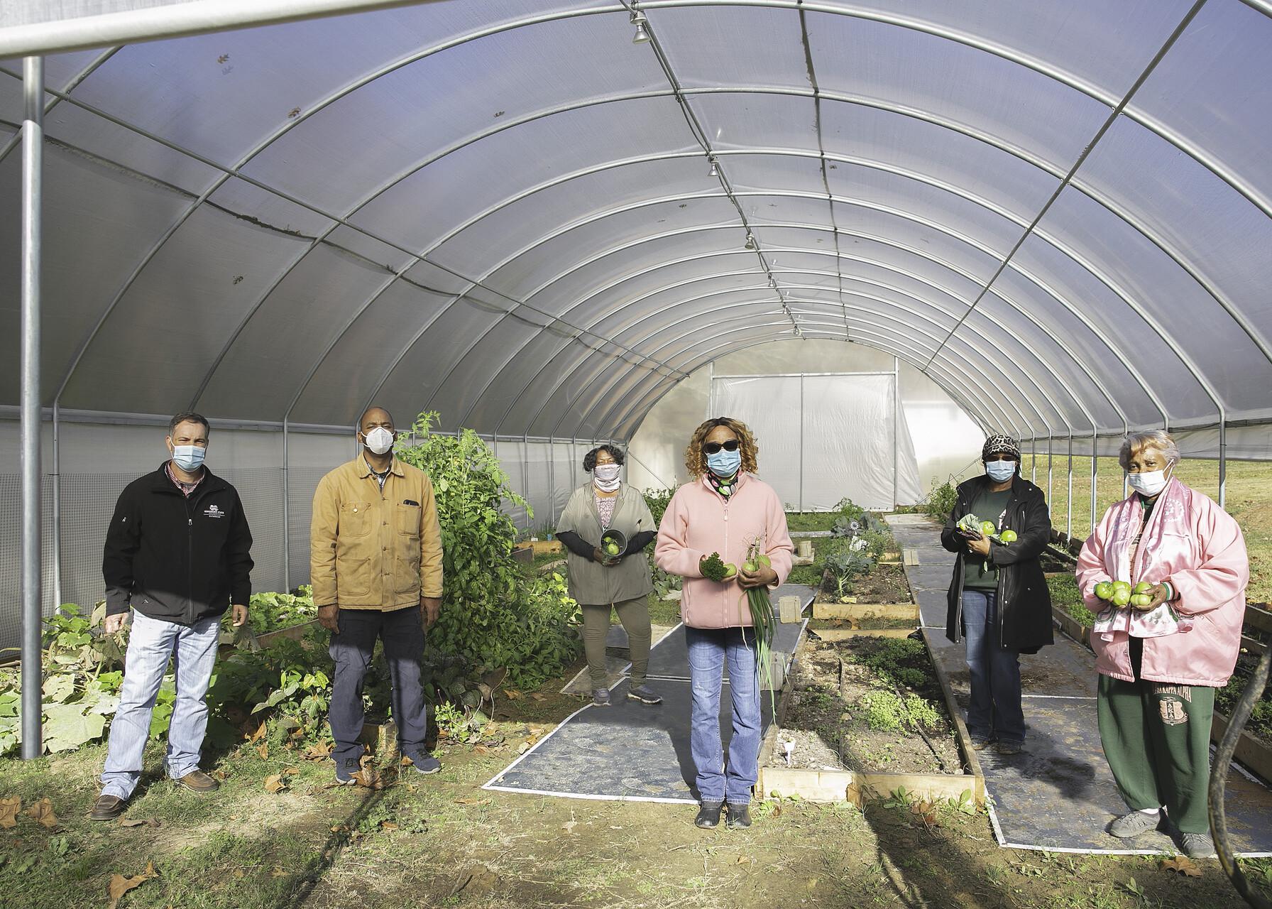 People stand in a garden.