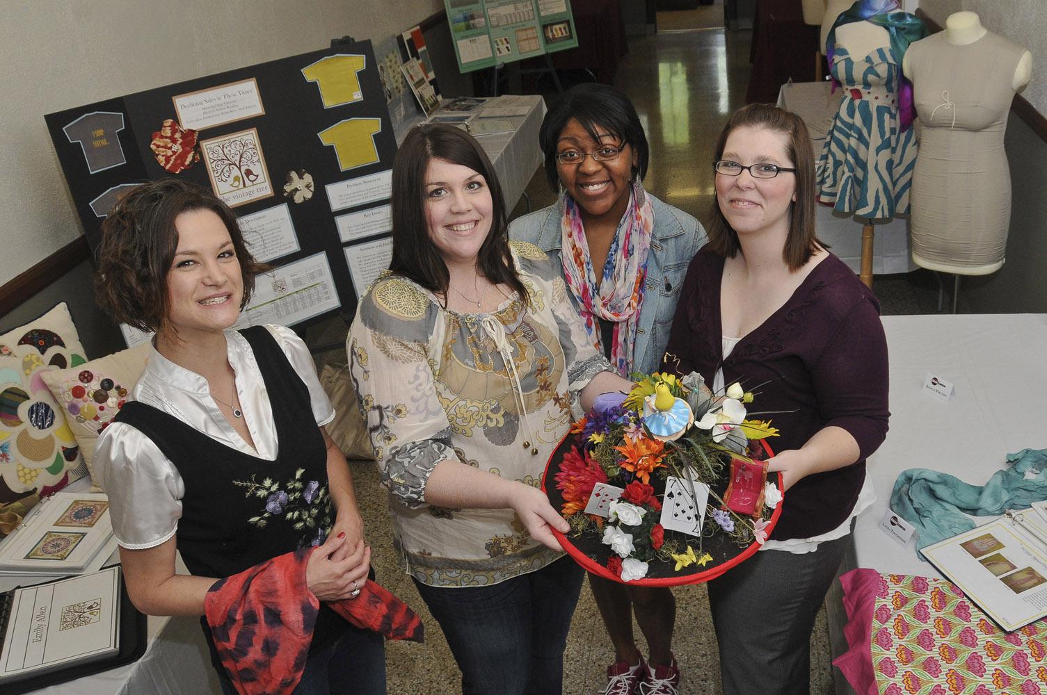 Robin Cox, a 1998 Mississippi State University graduate and corporate merchandise planner for national retailer JCPenney, met with students in the Apparel, Textiles and Merchandising program at MSU’s School of Human Sciences as part of the Senior Showcase, a celebration of 2012 graduates and their design work. From left: Erin Bridges, instructor; Robin Cox; Jessica Watts, a sophomore from Clinton; and Amelia Williams, a senior from Starkville. (Photo by MSU Ag Communications/Scott Corey)