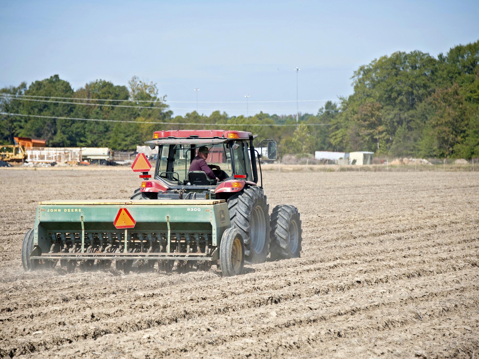 Wheat acreage is expected to be up from last year, but the ground across most of the state was too dry to plant through October. Blake Garrard is shown planting wheat last fall at the Mississippi State University Rodney Foil Plant Science Research Center in Starkville. (File photo by MSU Extension/Kat Lawrence)