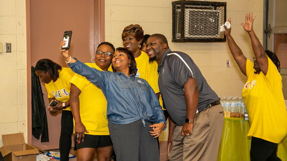 Four members of the Hollandale group Community Action for Healthy Lifestyles take a selfie with Extension agent Alexis Hamilton at the opening of their fitness center.