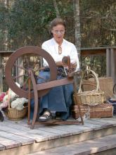 Yvette Rosen demonstrates spinning to guests of a previous Piney Woods Heritage Festival at Crosby Arboretum. The festival provides an opportunity to learn about the arts and heritage crafts of the region. (Photo courtesy of Crosby Arboretum)