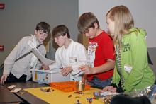 Jonathan Rodgers of DeSoto County, from left, Nick Murphy of Carroll County, Austin "Bubba" Meriweather of Leflore County and Kenzie Ellenberger of DeSoto County follow instructions to build a robot. The four joined other 4-H youth, volunteer leaders and agents at the recent kick-off of the 2012 robotics project at Mississippi State University. (Submitted Photo)