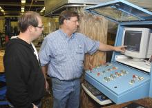 Segerstrom and Mississippi State University forest products professor Dan Seale press and test boards made from corn and kenaf fibers. (Photos by Scott Corey)