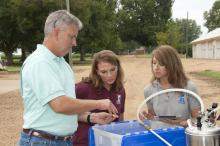 Proper water flow and proper chemical mix add up to a properly				calibrated sprayer that dispenses farm chemicals. Dan Reynolds shows Jamie Varner (left) and Kelli				McCarter spray tips of different sizes. (Photo by MSU Ag Communications/Kat Lawrence) 