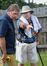 Gary Bachman (right), horticulture expert with Mississippi State University, reviews information with "Ask This Old House" landscape contractor Roger Cook. Bachman provided off-camera expertise for the segment filmed by the traveling home improvement show on Oct. 9 in Biloxi. The crew also recorded segments for the current season in Mobile on Oct. 8 and in New Orleans on Oct. 10. (Photo by MSU Ag Communications/Susan Collins-Smith)