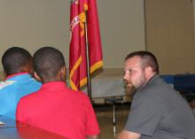 Tarra Blackwell of Collins, a Mississippi State University senior and member of the Air National Guard, shares the meanings behind the symbols on the Air Force flag at a meeting of the Controllers Generation II 4-H Club in Maben on Oct. 21, 2013. (Photo by MSU Ag Communications/Keri Collins Lewis)