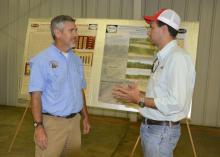 Mississippi State University grain crops agronomist Erick Larson, left, visits with Cuzzi Jonas of Brazil during the North Mississippi Research and Extension Center's Agronomic Row Crops Field Day in Verona, Mississippi, on Aug. 7, 2014. (Photo by MSU Ag Communications/Linda Breazeale)