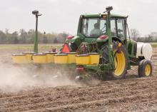 A Mississippi State University worker at the Northeast Mississippi Branch Experiment Station in Verona takes advantage of the ideal weather for corn planting on April 7. (Photo by Scott Corey)