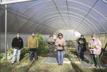 People stand in a garden.