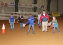 Chickasaw County Emergency Management Agency Director Linda Griffin, second from right, teaches 4-H members how to use found objects to save someone who is drowning during a meeting of the 4-H sportfishing club April 14, 2016, at the Chickasaw County Agricenter. (Photo by MSU Extension Service/Kat Lawrence)