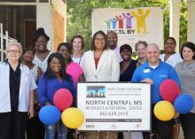 Members of Mississippi State University Extension Service, the Early Years Network and Excel by 5 celebrated the grand opening of the North Central Mississippi Resource and Referral Center with Durant Mayor Tasha Davis (center) and community members on Aug. 2, 2016. The center provides early child care educators, families and other residents in Holmes County a place to visit and borrow educational books, toys and games. (Photo by MSU Extension Service/Alexandra Woolbright)