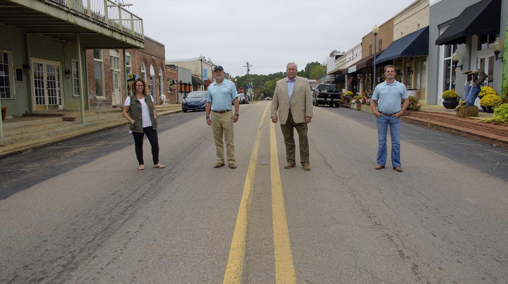 Four people stand on Main Street in Saltillo, MS.