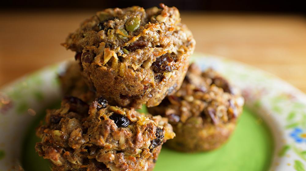 Five baked muffins loaded with fruit and nuts on a green floral plate. (Photo by MSU Extension Service/Kevin Hudson)