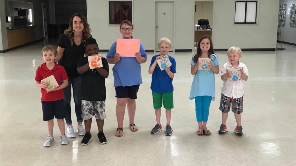 Office Associate, Katelyn Bailey with the 4-H Handy Helpers Club group.