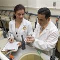 Attila Karsi, research assistant professor at Mississippi State University's College of Veterinary Medicine, and Nagihan Gulsoy, a visiting professor, examine a catfish fingerling with the disease enteric septicemia, a bacterial disease that costs the catfish industry millions of dollars each year. (Photo by Tom Thompson)