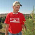 Mississippi Christmas tree grower Michael May examines a 4-year-old Leyland Cypress on his farm, Lazy Acres Plantation in Chunky. (Photo by Patti Drapala)