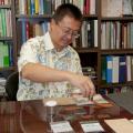 Mississippi State University forest products assistant professor Sheldon Shi demonstrates the effectiveness of magnetic charcoal. Shi and his colleague Dongmao Zhang found a new way to create charcoal and other carbon-based products with a higher absorption capacity.