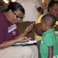 Margie Moore, left, with the Mississippi Child Care Resource & Referral Network's Project Navigator, reviews educational materials with Sherris and Curtis Grace of DeKalb.