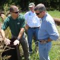 Mississippi State University professor of aquatic sciences Robbie Kroger (left) demonstrates how a riser pipe works to trap sediment and increase water quality to Ben Scaggs (right), director of the Environmental Protection Agency's Gulf of Mexico Program and Phil Bass (center), executive director of the Gulf of Mexico Alliance. The site visit was part of a new conservation initiative called Research and Education to Advance Conservation and Habitat. (Submitted Photo)