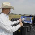 Mississippi State University Extension Service forage specialist Rocky Lemus examines a bermudagrass analysis from a portable forage tester on May 21, 2012, at the Henry H. Leveck Animal Research Farm, the forage unit at MSU's South Farm in Starkville. Forage and cattle producers can use test results to make harvest and feed supplement decisions. (Photo by MSU Ag Communications/Linda Breazeale)