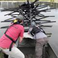 Mississippi State University students Jason Bies, left, and Clint Lloyd install an artificial, commercially-available fish habitat at Blackjack Pond on the MSU campus. (Photo by MSU Extension Service/Wes Neal)