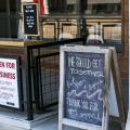 Signs with instructions for ordering curbside greet customers at a local coffee shop 