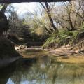 A shallow creek between two hills.