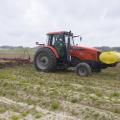 Man on a tractor plants corn.