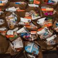 Paper bags are filled with grocery items.