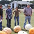 Extension agricultural agents review pumpkins recently harvested at County Pumpkins in Lowndes County. The fall tour participants include, from left, Jeff Wilson of Lowndes County, farm owner Dwight Colson of Caledonia, Kimberly Wilborn of Lamar County, Julie White of Oktibbeha County and Reid Nevins of Lowndes County. (Photo by MSU Ag Communications/Scott Corey)