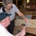 Pine Belt Master Gardeners Gerald Good and Margaret Thomas mark the 100th salad table built by the group during a workday in Purvis June 19, 2014. The table will be donated to the University of Southern Mississippi's Department of Sustainability. (Photo by MSU Ag Communications/Susan Collins-Smith)