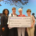 Representatives of the Early Years Network and UnitedHealthcare take part in a check presentation ceremony during the grand opening of the Hinds County Resource and Referral Center at 350 West Woodrow Wilson Avenue in Jackson, Mississippi on June 25, 2015. Celebrating their newly formed partnership are Kenisha Potter, left, pediatric health care coordinator for UnitedHealthcare; Louise E. Davis, professor with the Mississippi State University Extension Service and director of the Early Years Network; Connie