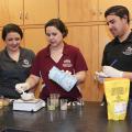 Mississippi State University junior Morgan Von Staden of Olive Branch, Mississippi, and graduate students Liz Ivey of Cumming, Georgia and Hector Portillo of Sarasota, Florida are members of a Department of Food Science, Nutrition and Health Promotion student team developing a product made of culled sweet potatoes that cafeterias could use to increase the nutritional value of school lunches. (Photo by MSU Extension Service, Kat Lawrence)