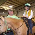 Volunteers and riders will be featured at Mississippi State University’s second annual Therapeutic Riding Expo at the Mississippi Horse Park on April 19. This file photo shows Lantz Stewart of West Point offering advice to Eli Barlow before they enter the arena for the first riding exposition in 2015. (Photo by MSU Ag Communications/Linda Breazeale)