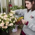 A good florist will help make decisions on what flowers and colors to include in a wedding. Here, Mississippi State University senior Meryl Williams of Columbus selects flowers and foliage for a corsage project in her wedding floral design class. (Photo by MSU Ag Communications/Scott Corey)